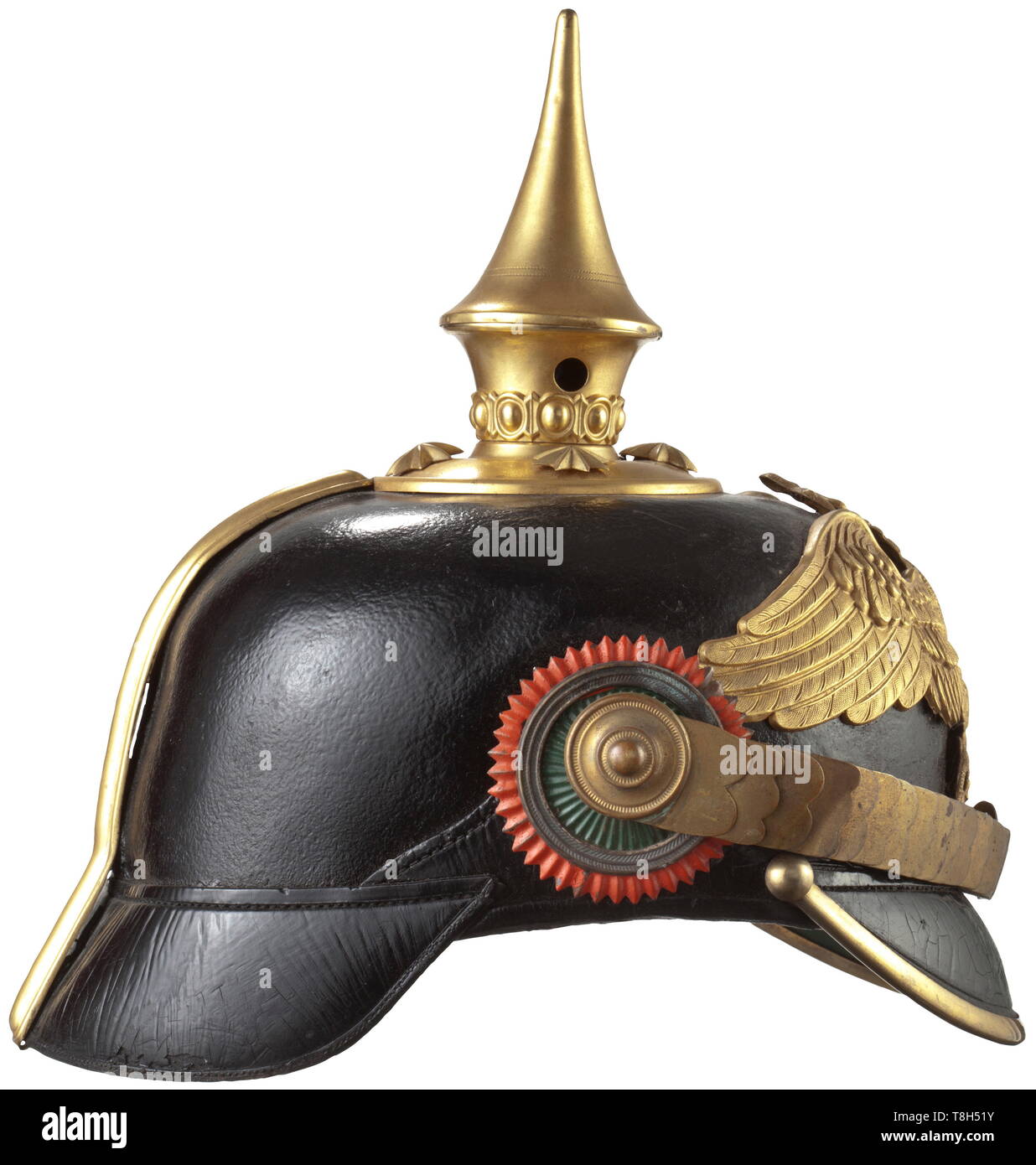 A helmet for officers of the land forces, circa 1900 Version after a German model. Black lacquered leather skull with gilt brass mounts, green and red lined visors, green silk rep lining (name tag) with fine leather sweatband. Emblem in the form prior to 1893: an eagle with outstretched wings and a snake in its beak perched on an opuntia (cactus tree). Flat chinscales (a few links bent) on pin rosettes, the multi-piece cockades lacquered in the national colours. historic, historical, Mexican, Mexico, Central America, American, 19th century, Additional-Rights-Clearance-Info-Not-Available Stock Photo