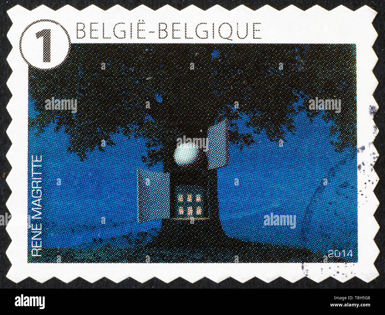 Surrealistic painting by Magritte on belgian postage stamp Stock Photo