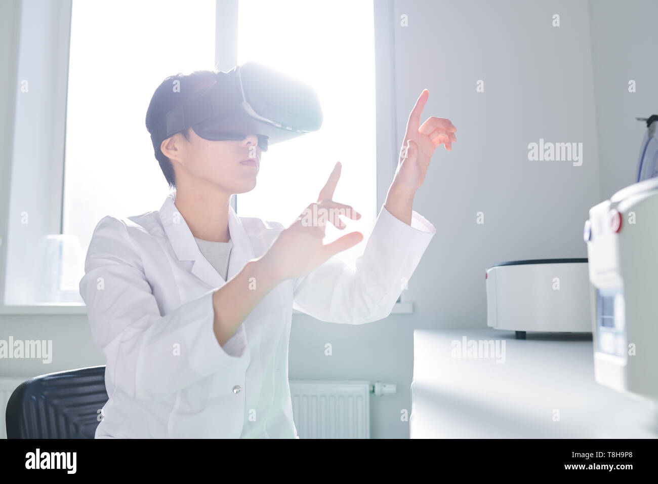 Asian innovation scientist using VR simulator Stock Photo