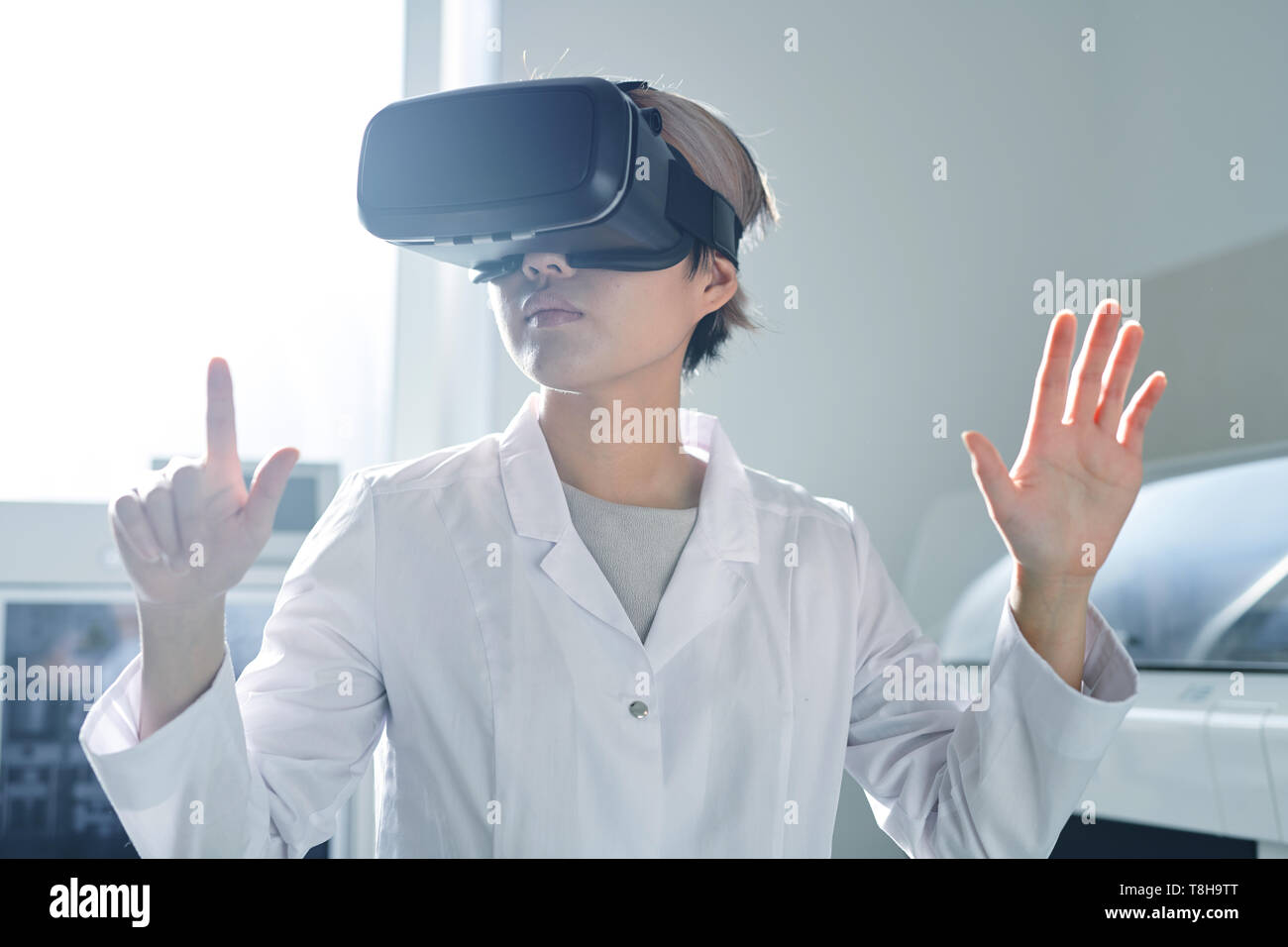 Lady scientist editing research information via VR simulator  Stock Photo