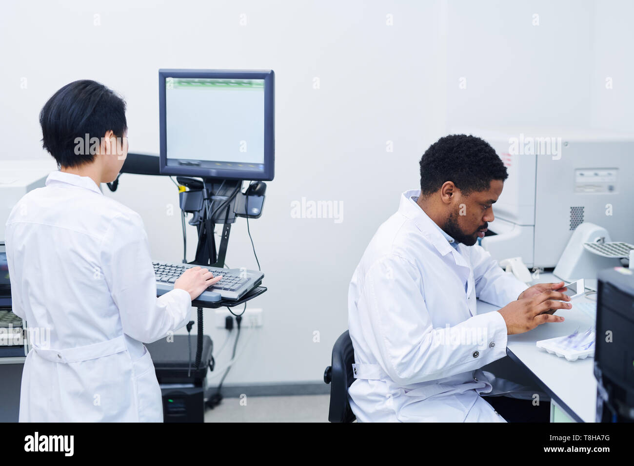 Hospital Specialists Working On Modern Equipment Stock Photo Alamy