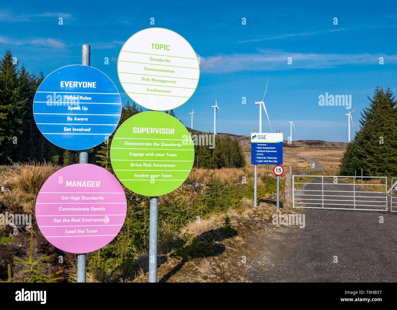 Scottish and Southern Energy (SSE) company policy safety notices and wind turbines on hill at Griffin wind farm, Perthshire, Scotland, UK Stock Photo
