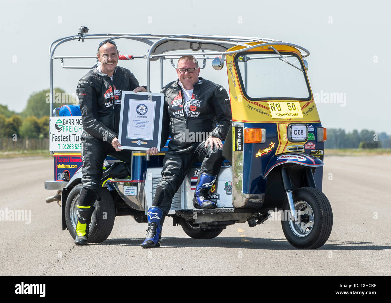 Essex businessman Matt Everard (right) and passenger Russell Shearman celebrate their Guinness World Record after setting the world land speed record in a tuk tuk at Elvington Airfield in Yorkshire. Stock Photo