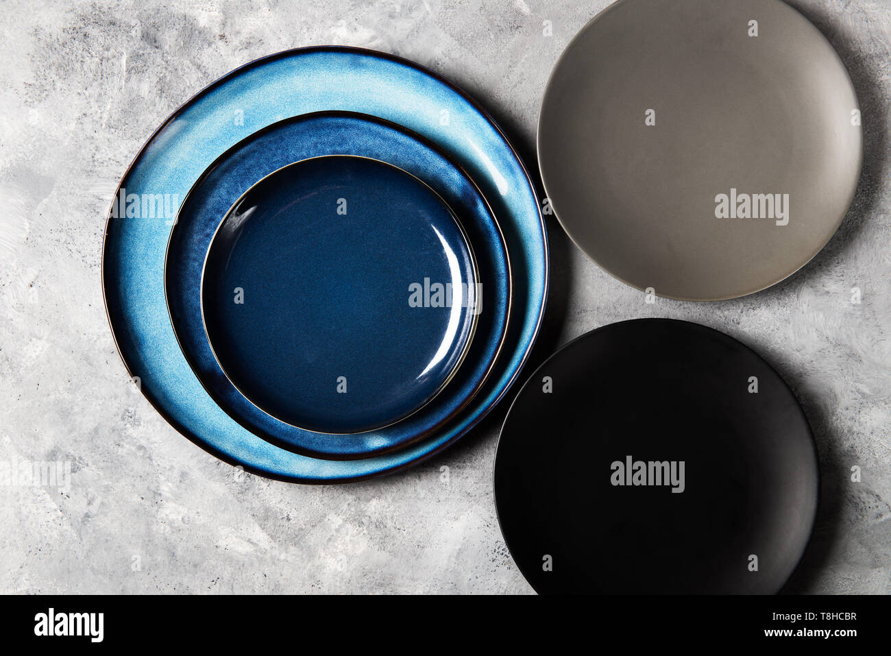 Empty Blue Plates on Grey Background Stock Photo