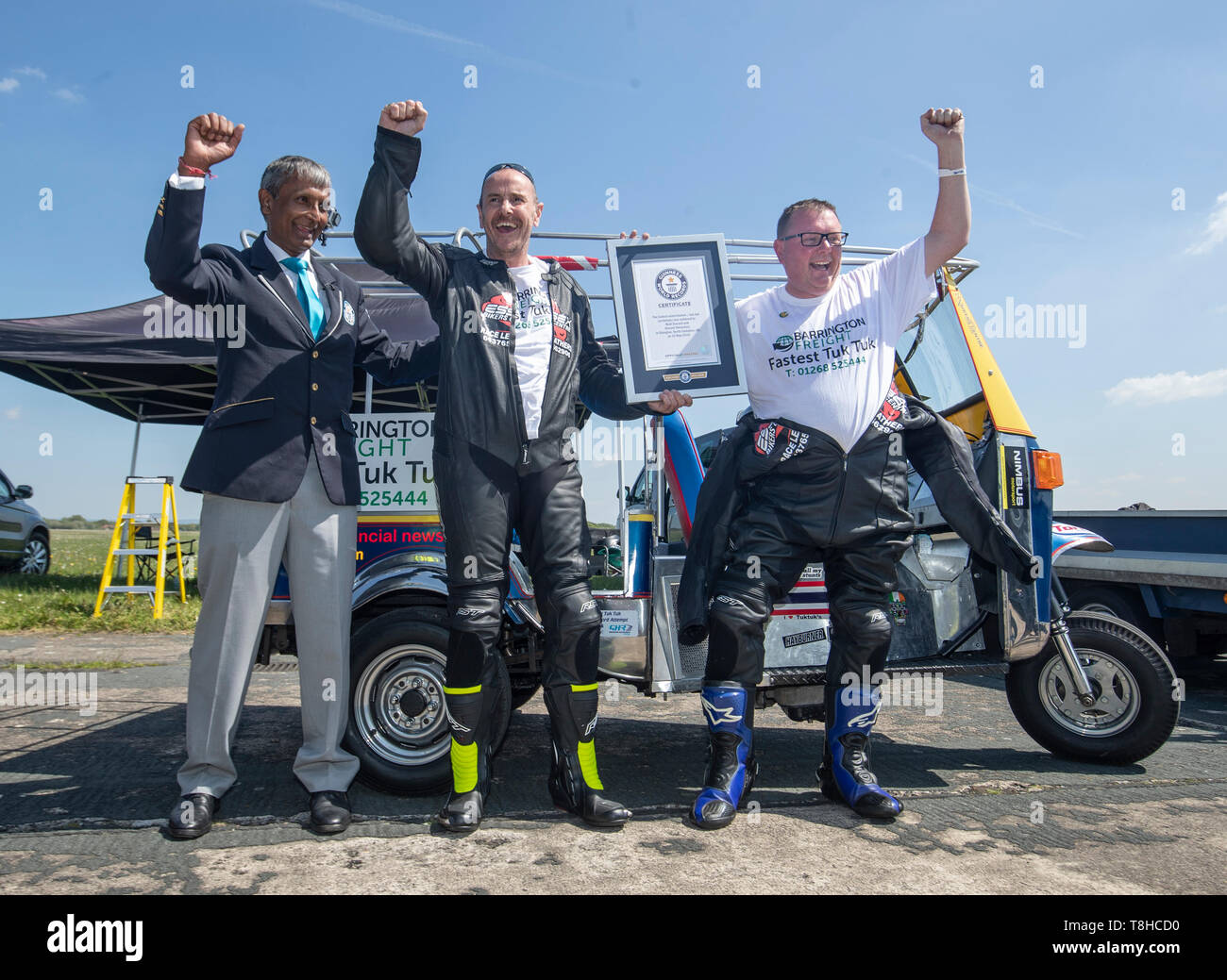 Essex businessman Matt Everard (right) and passenger Russell Shearman with Guinness World Records adjudicator Pravin Patel (left) as they celebrate their Guinness World Record after setting the world land speed record in a tuk tuk at Elvington Airfield in Yorkshire. Stock Photo