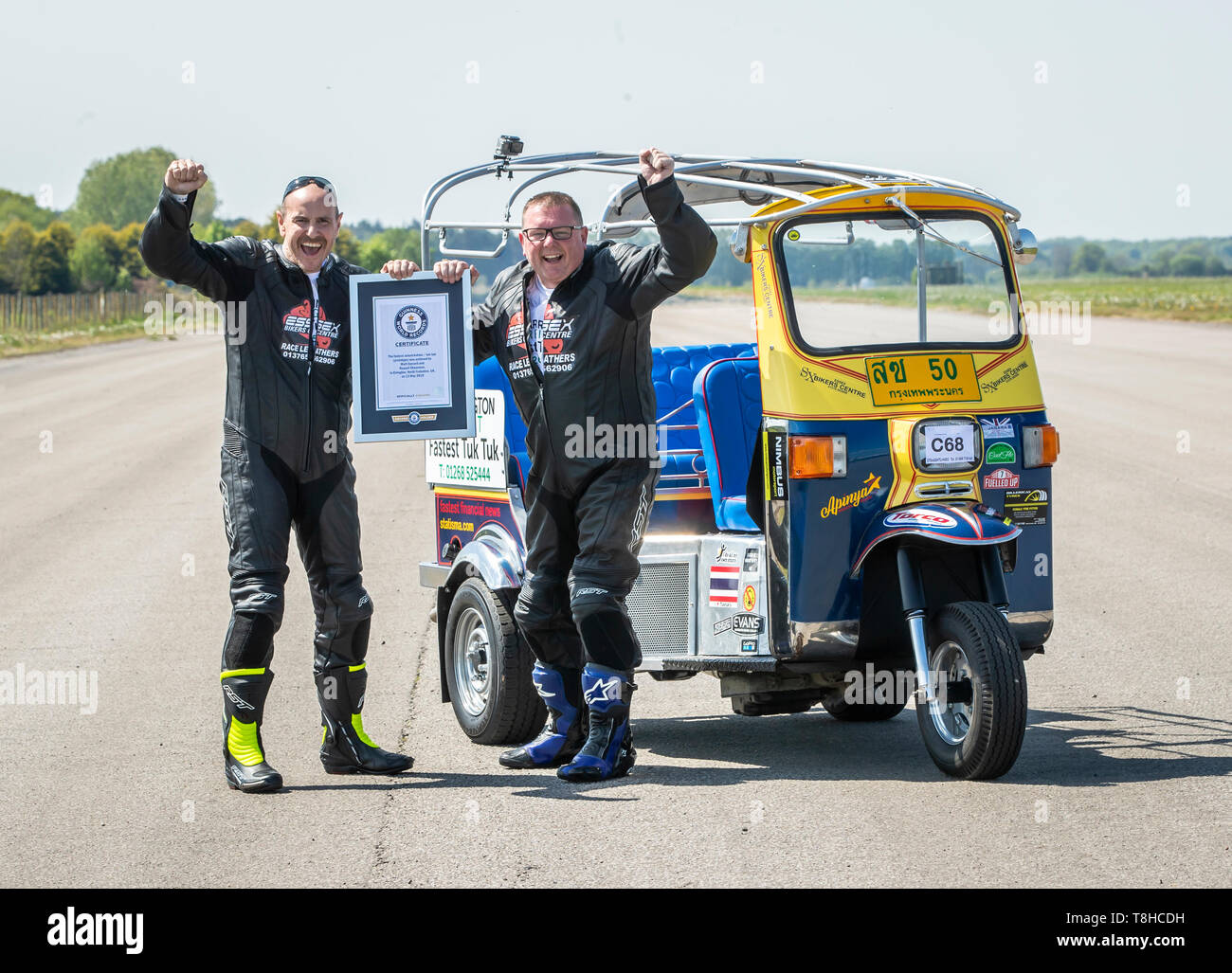 Essex businessman Matt Everard (right) and passenger Russell Shearman celebrate their Guinness World Record after setting the world land speed record in a tuk tuk at Elvington Airfield in Yorkshire. Stock Photo