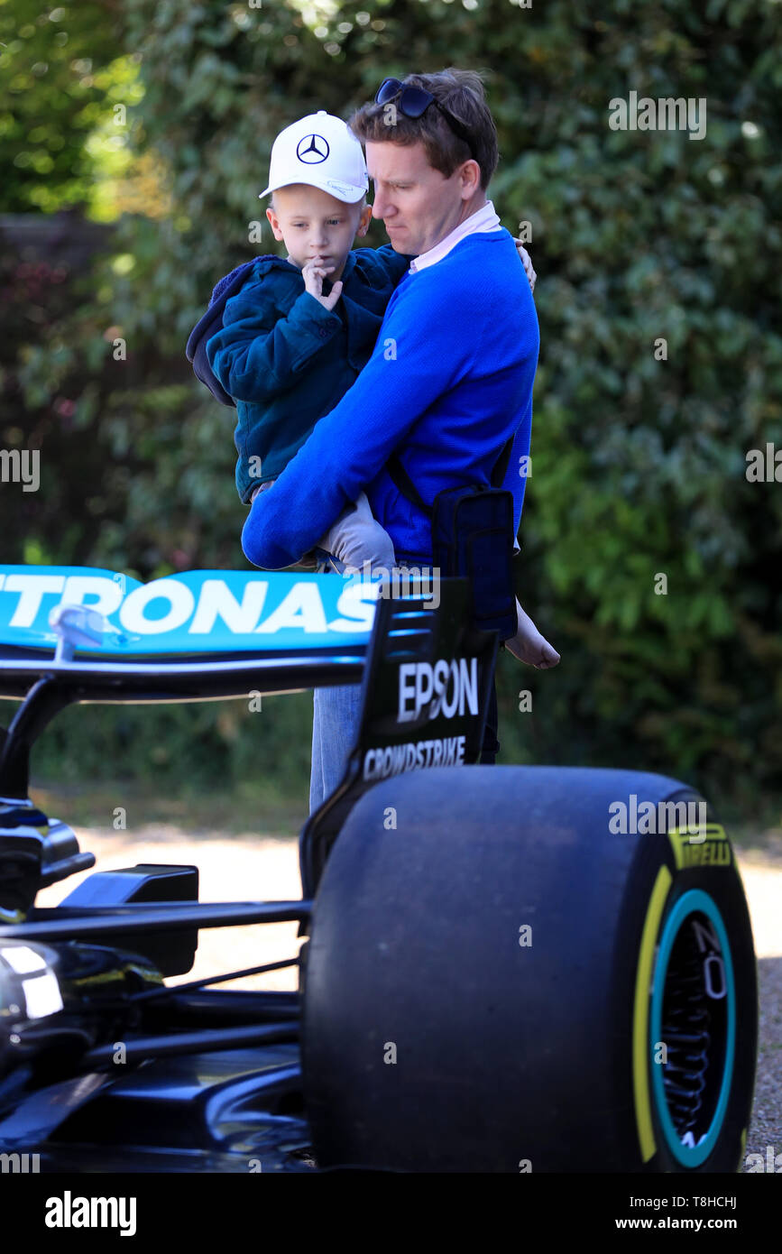Five-year-old Harry Shaw, who has been diagnosed with a rare form of bone cancer, is carried by his father James to view a replica of Lewis Hamilton's Formula 1 car outside their home in Redhill, Surrey. Stock Photo