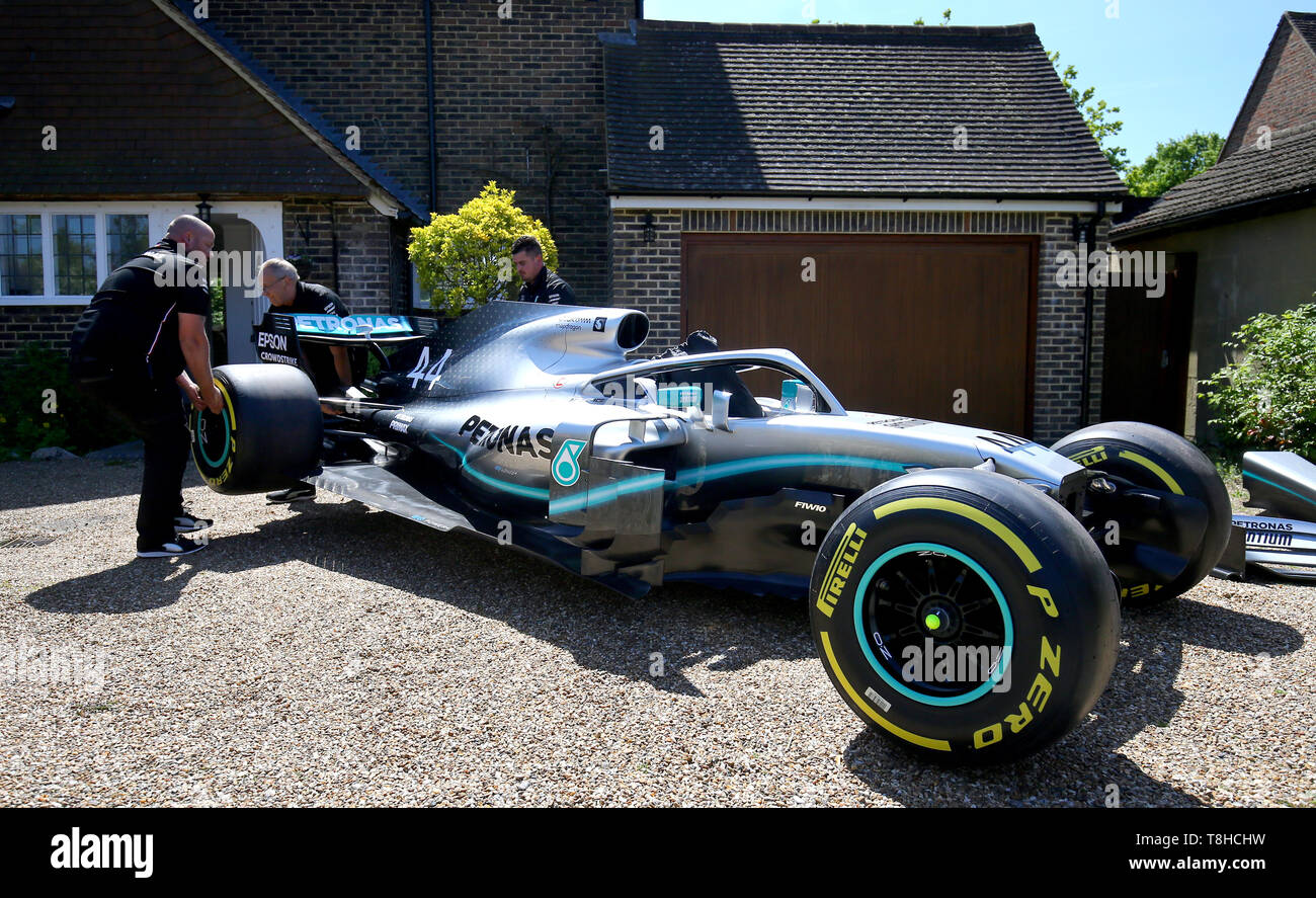 Members of the Mercedes Formula One team deliver a replica of Lewis  Hamilton's Formula 1 car to the home of five-year old Harry Shaw in  Redhill, Surrey, who has been diagnosed with