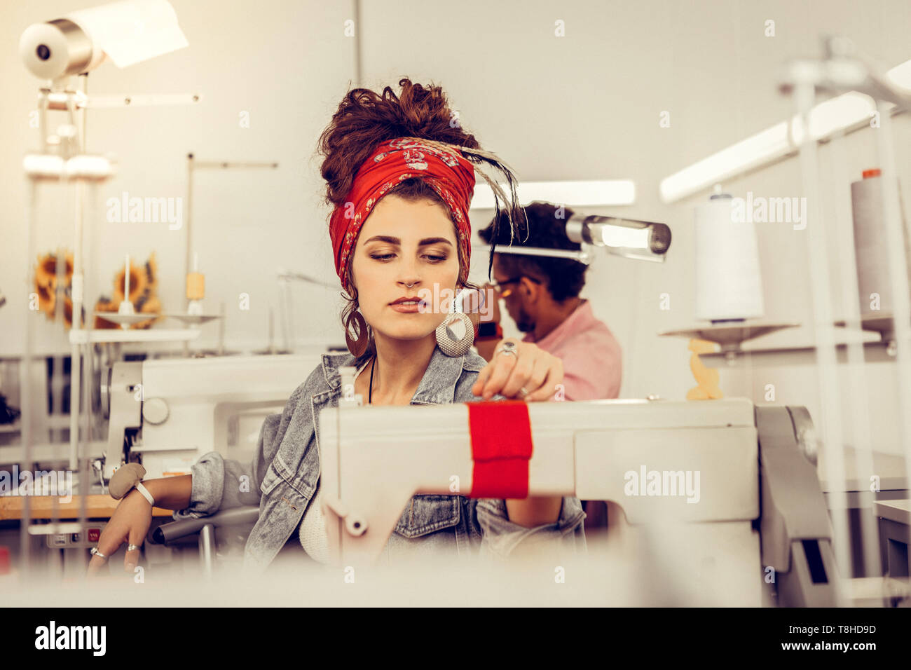 Two young tailors working on sewing machines Stock Photo