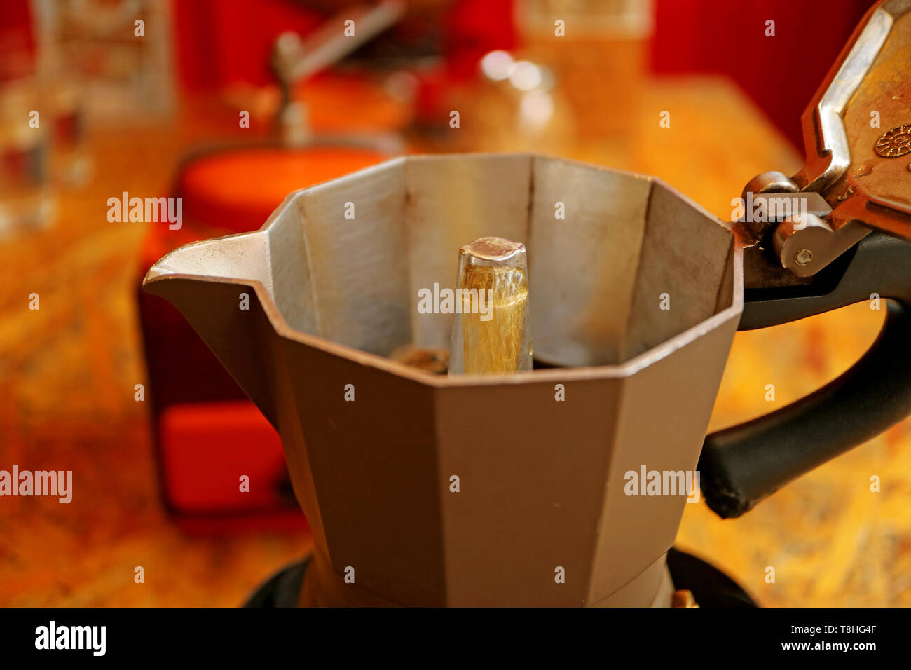 Boiling water running through the strainer of ground coffee creating a