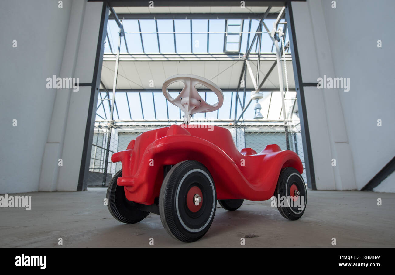 Halle, Germany. 13th May 2019. A Bobby-Car stands in a parking cell of the  large garage Halle-Süd in Halle/Saale. An artist duo from Halle has won the  competition "Think Bauhaus" of the