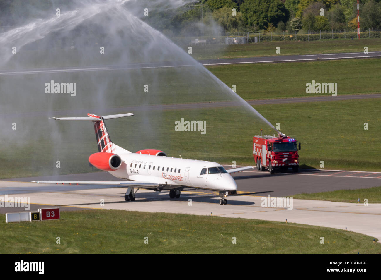 Scottish airline Loganair have become the latest airline to launch services from the expanding London Southend Airport, Essex, UK  with routes commencing to Aberdeen. The flights will be served using Embraer ERJ135 or 145 aircraft with Loganair's tartan tail scheme. A traditional water arch salute was supplied by the airport's fire trucks welcoming the afternoon's flight LM95 arrival from Aberdeen. Stock Photo