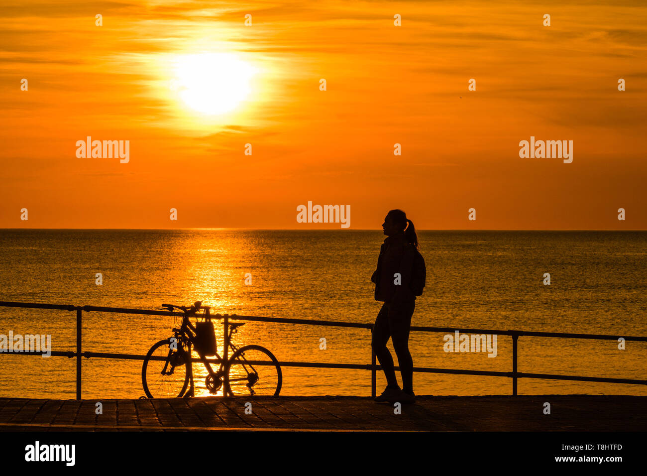 Aberystwyth Wales UK, Monday 13 May 2019  UK Weather: A glorious golden sunset over the waters of Cardigan Bay at Aberystwyth , bringing to an end a day pf unbroken warm spring sunshine as a high pressure system dominates the weather over the whole of the UK . photo credit Keith Morris / Alamy Live News Stock Photo