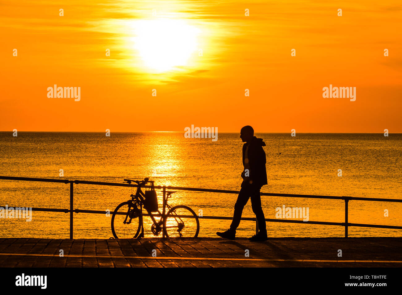 Aberystwyth Wales UK, Monday 13 May 2019  UK Weather: A glorious golden sunset over the waters of Cardigan Bay at Aberystwyth , bringing to an end a day pf unbroken warm spring sunshine as a high pressure system dominates the weather over the whole of the UK . photo credit Keith Morris / Alamy Live News Stock Photo