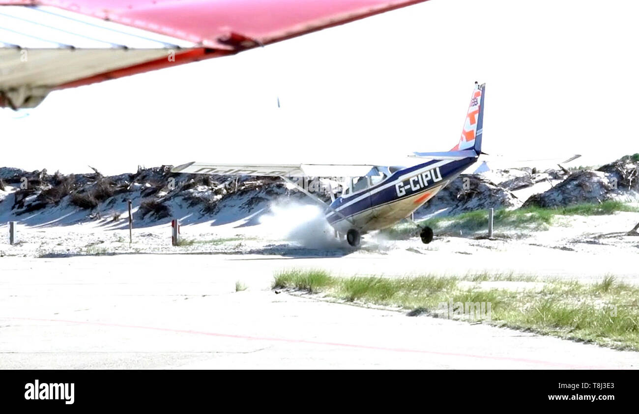 Helgoland, Germany. 14th May, 2019. A single-engine aircraft from Great Britain comes off the runway and drives into the sand when it fails to land at the Helgoland airfield. Nobody was injured in the accident on Germany's shortest runway on the dune near Helgoland. (best possible quality) Credit: Carsten Rehder/dpa/Alamy Live News Stock Photo
