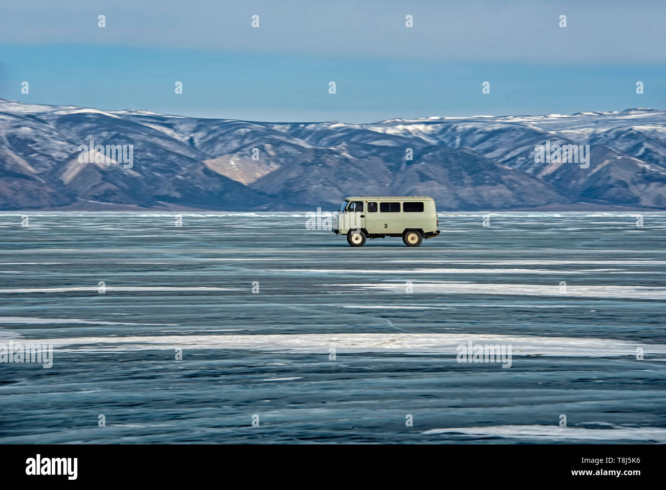 Van driving across Lake Baikal, Siberia, Russia Stock Photo