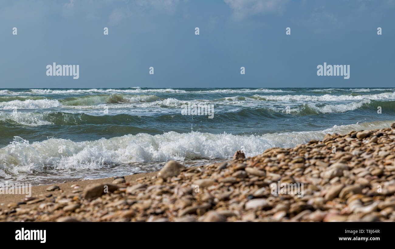 the ocean near tel aviv in israel with waves and rocks on the beach ...