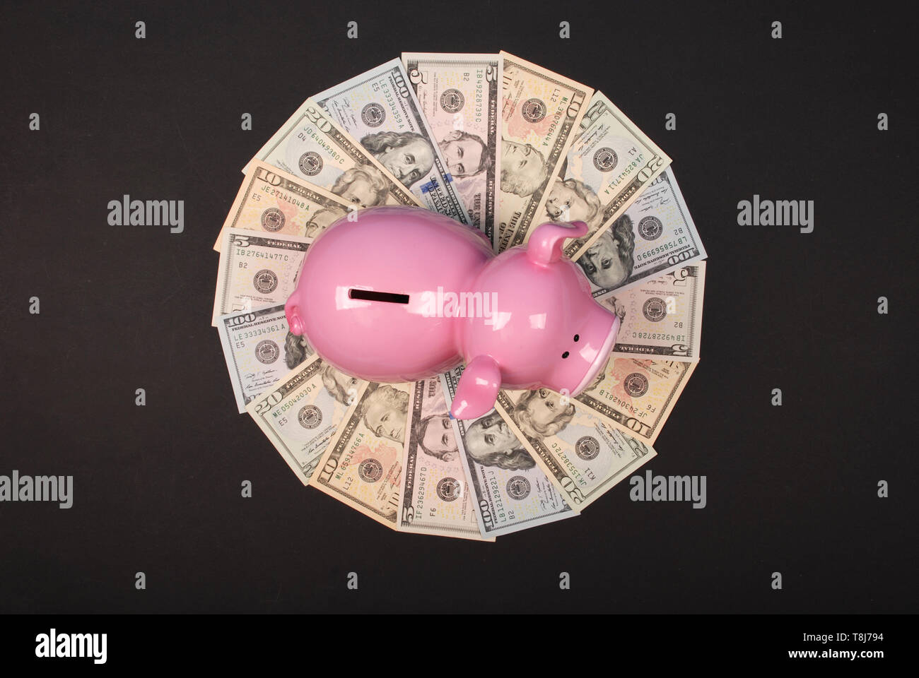 Piggy bank on mandala kaleidoscope from money. Abstract money background raster pattern repeat mandala circle. Stock Photo