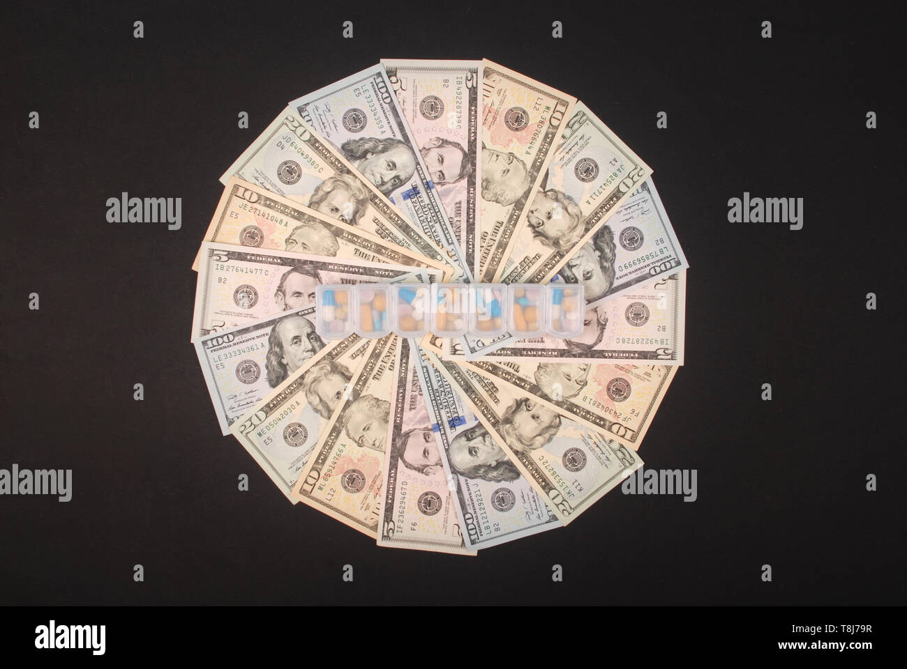 Pill box on mandala kaleidoscope from money. Abstract money background raster pattern repeat mandala circle. Stock Photo