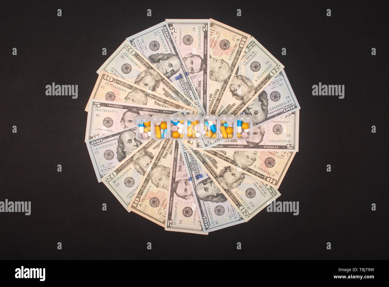 Pill box on mandala kaleidoscope from money. Abstract money background raster pattern repeat mandala circle. Stock Photo