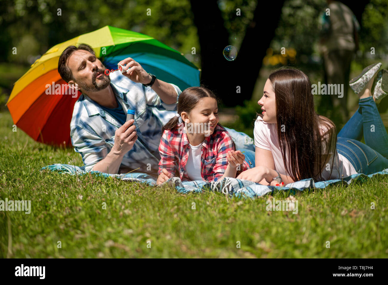 Happy family enjoying time in summer park Stock Photo
