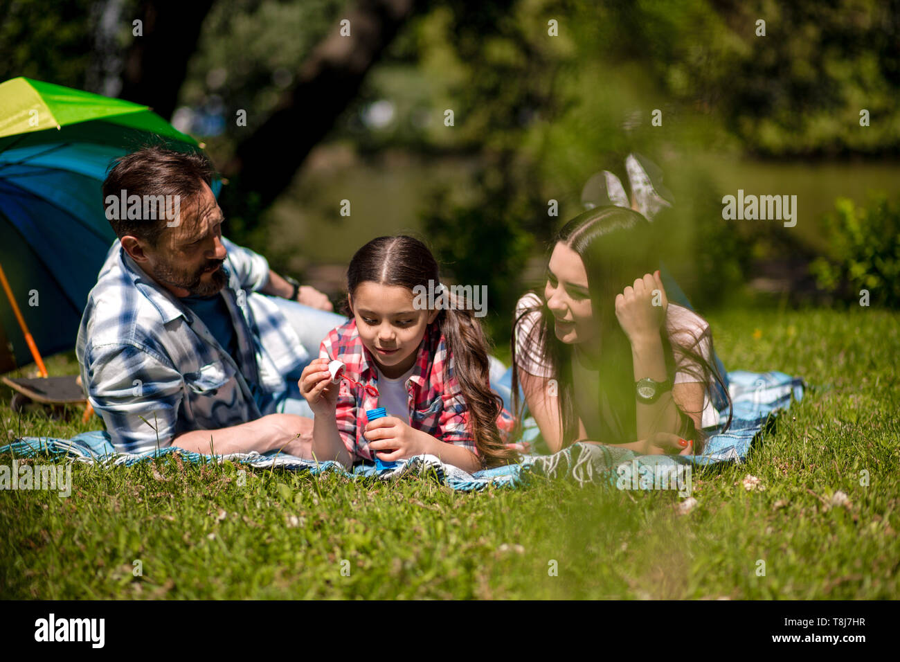 Happy family enjoying time in summer park Stock Photo