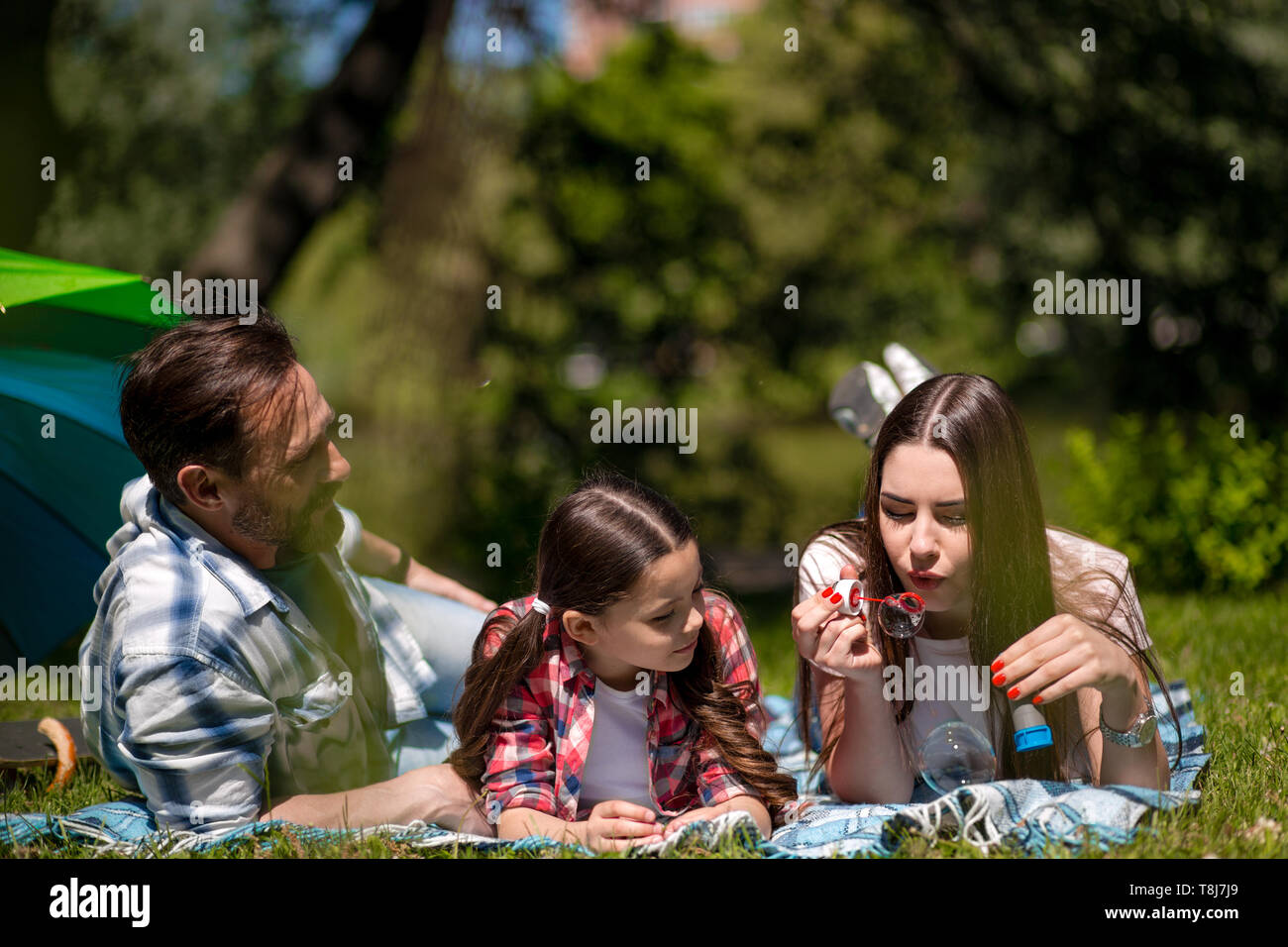 Happy family enjoying time in summer park Stock Photo