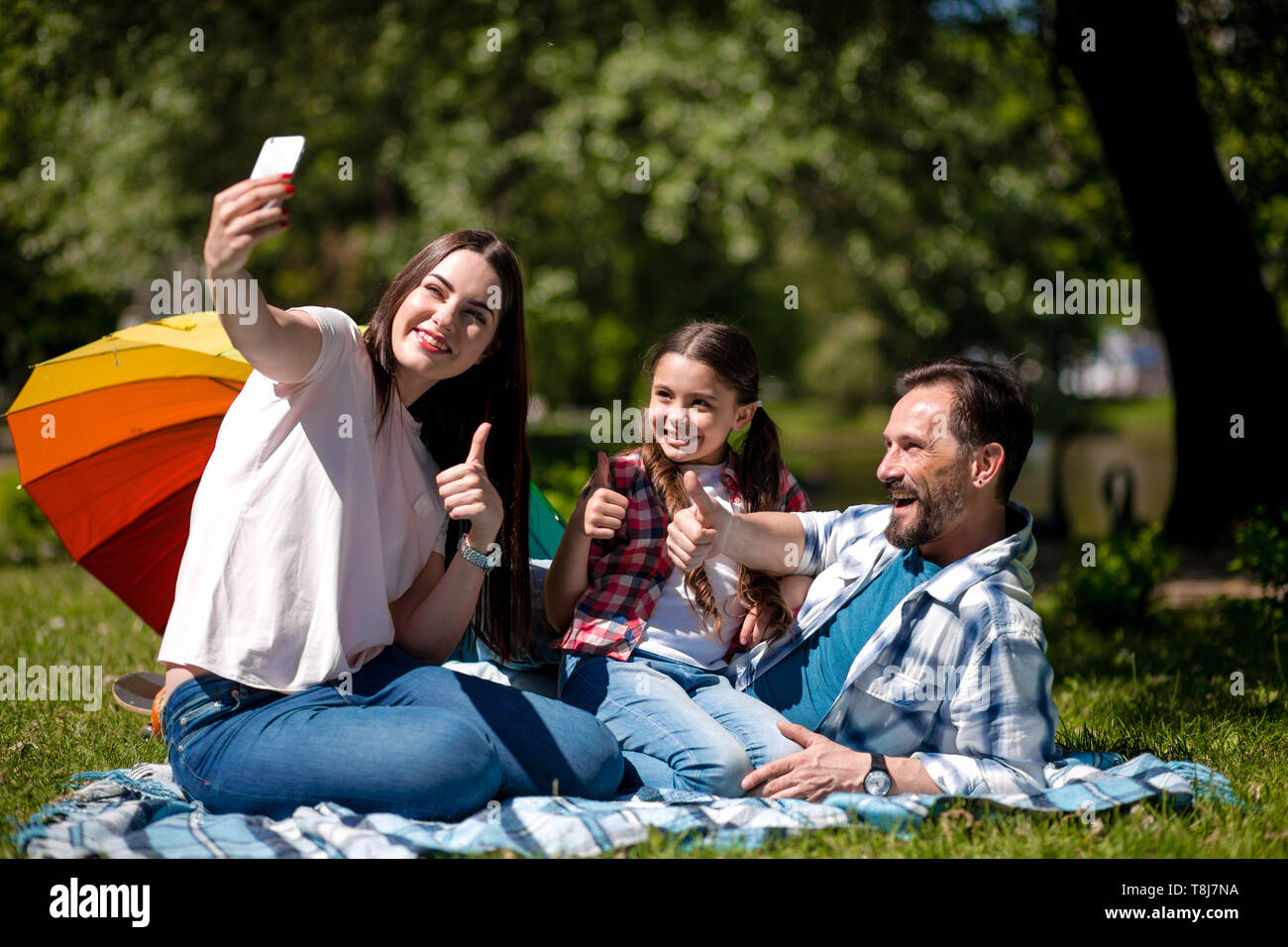 Happy family enjoying time in summer park Stock Photo