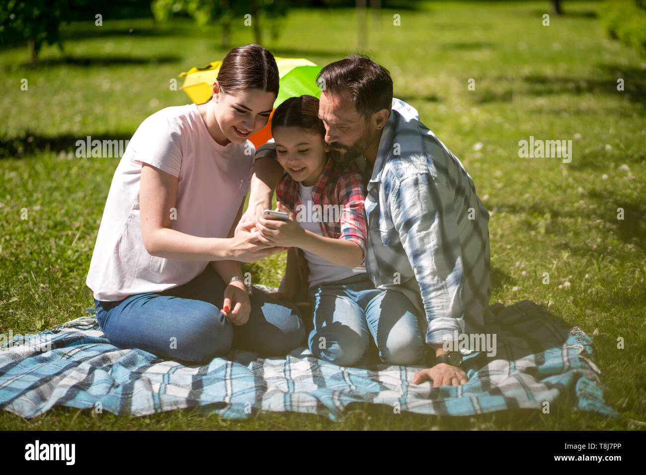 Happy family enjoying time in summer park Stock Photo