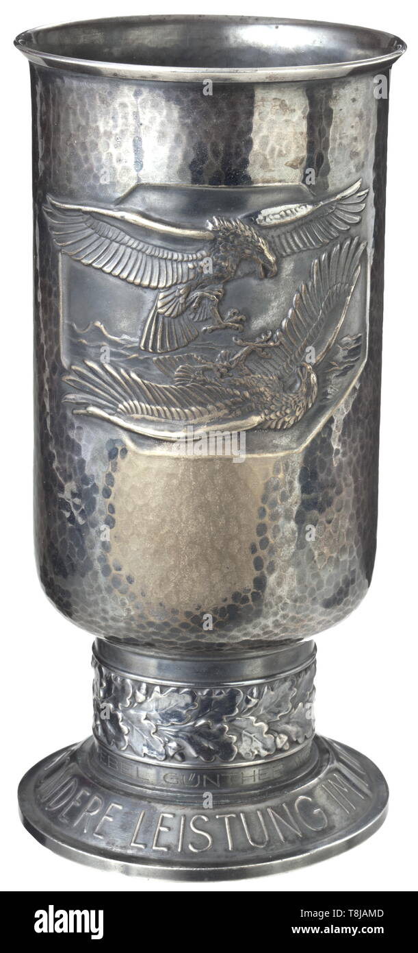 A Goblet of Honour for outstanding achievement in theaAir warfare of Me 262 pilot Wegmann Silvered issue with engraving 'Feldwebel Günther Wegmann am 21.1.43', the base punched 'Feinsilber Auflage - Alpaka - Joh. Wagner & Sohn', the pedestal slightly knocked. Very beautiful patina. Height 21 cm. Oberleutnant Günther Wegmann achieved the first of his 15 aerial victories, an American 'Liberator', as an NCO with ZG 26. Following two further victories and having already been promoted to Leutnant, he received the German Cross in Gold on 31 August 1943. In mid-1944 he was transfe, Editorial-Use-Only Stock Photo