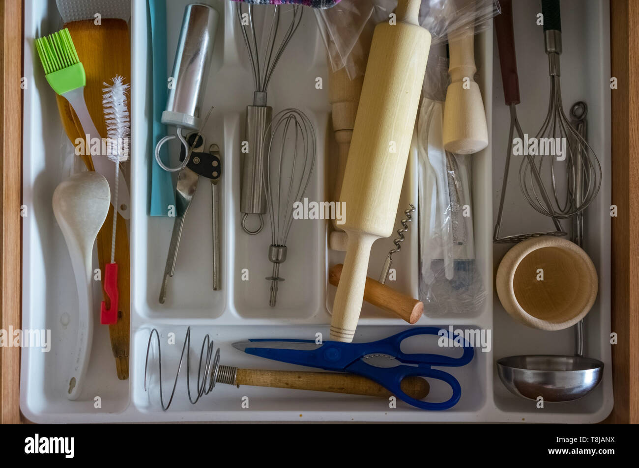 Top view of kitchen organizer with utensils and tools: beaters, blue ...