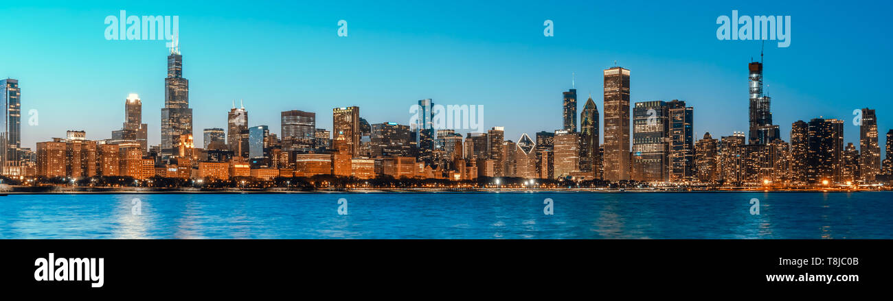 Beautiful cityscape panorama view of buildings in Chicago downtown district at twilight blue hour, banner size. America tourism, travel destination Stock Photo