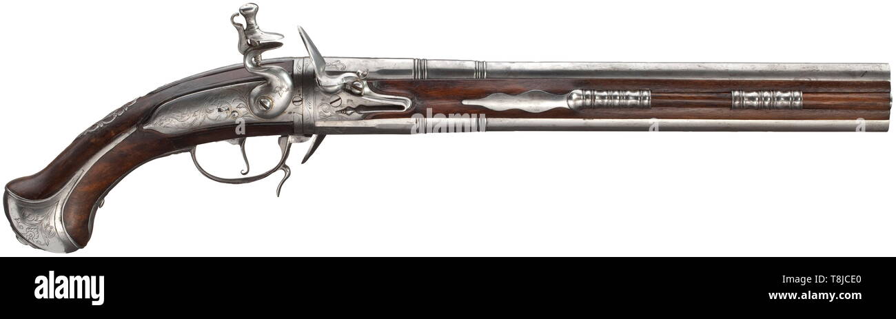 A Flemish flintlock wender pistol, circa 1700 Doubly stepped barrels, octagonal then hexadecagonal then round. Smooth bores in 15 mm calibre. The frizzens with engraved tendrils decoration, the lids of the frizzens with superimposed, riveted striking surfaces. The curved lock plate with engraved tendrils decoration. The side plate in delicate openwork with grotesque heads. Walnut stock with engraved iron furniture and openwork escutcheon. An expert repair underneath the lock. At the side a dovetailed wooden ramrod with iron tip. Length 54 cm. his, Additional-Rights-Clearance-Info-Not-Available Stock Photo