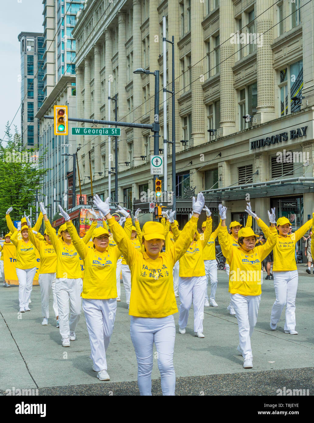 Falun Dafa, also known as Falun Gong, practitioners march in parade through streets of downtown Vancouver on Mother's Day 2019. Stock Photo