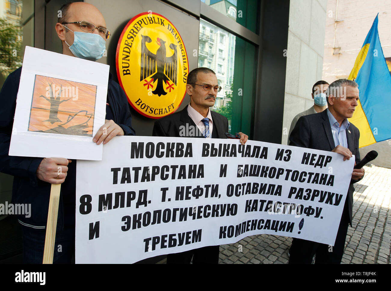 Protesters are seen holding a banner saying Moscow pumped 8 billion tons of oil from the depths of Tatarstan and Bashkortostan, leaving devastation and environmental disaster during the demonstration. The protest due with reports of pollution of the Russian export oil 'Urals' and high content of organic chloride compounds in it and the demand to initiate an independent international audit of Russian oil production and the Russian Transneft, as well as export-oriented Russian companies Rosneft, Tatneft and Bashneft, the protest was held in front of the German Embassy due to the fact that German Stock Photo