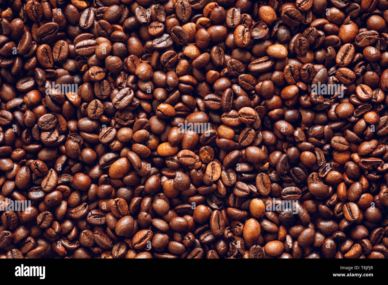 Roasted coffee beans texture background Stock Photo - Alamy