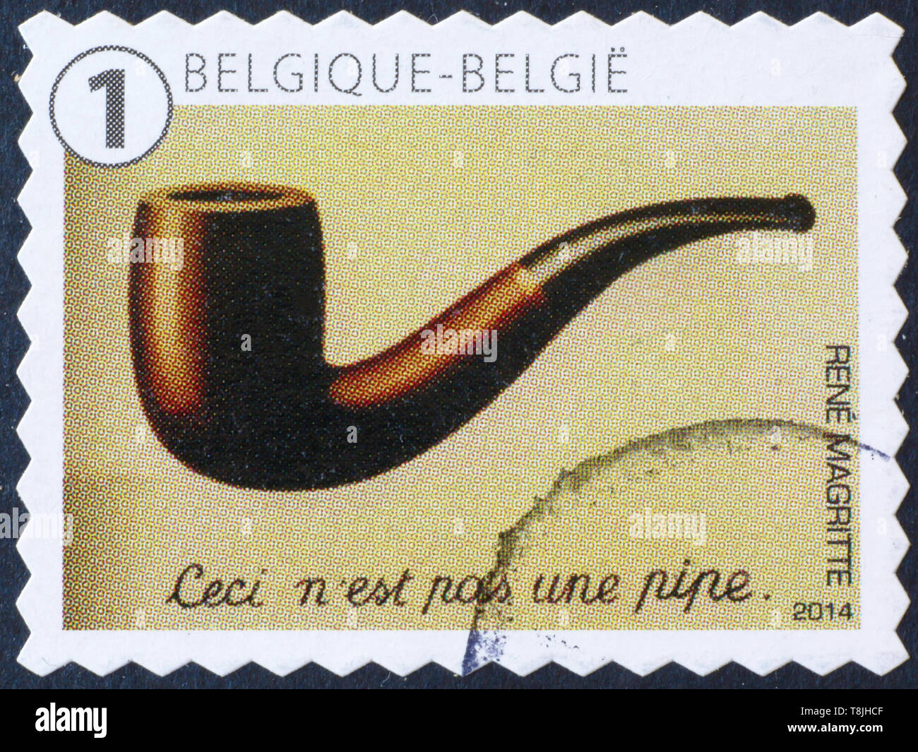 Famous surrealistic painting by Magritte on postage stamp Stock Photo