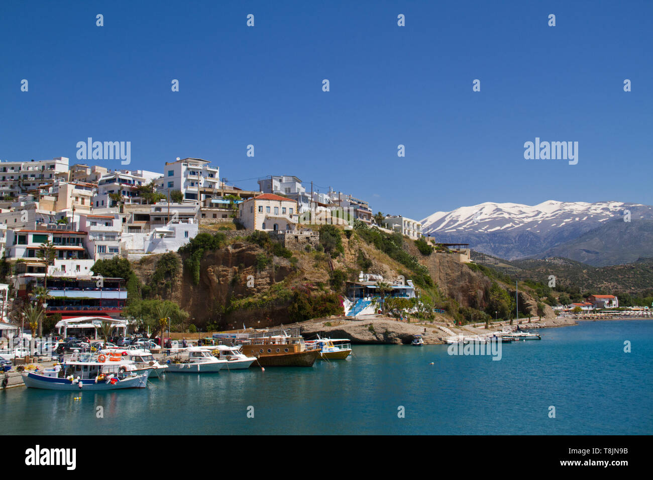 View on the charming fisherman’s village Agia Galini on the South coast of Crete, in the background the snow-covered Idi Mountains Stock Photo