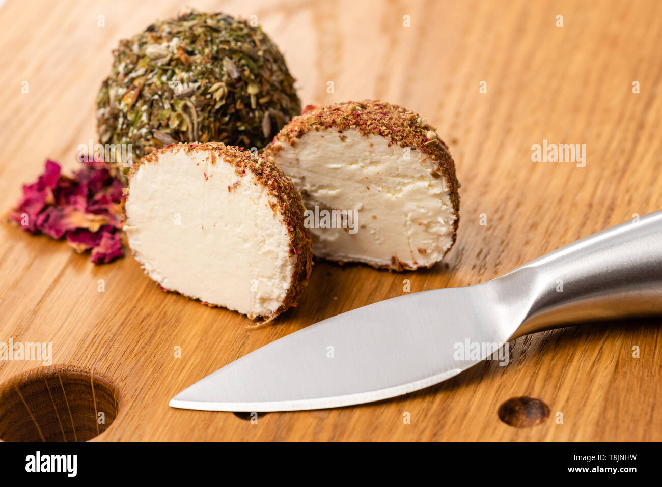 Close-up of soft cheese balls labne with spices. Cheese ball cut in half. Stock Photo