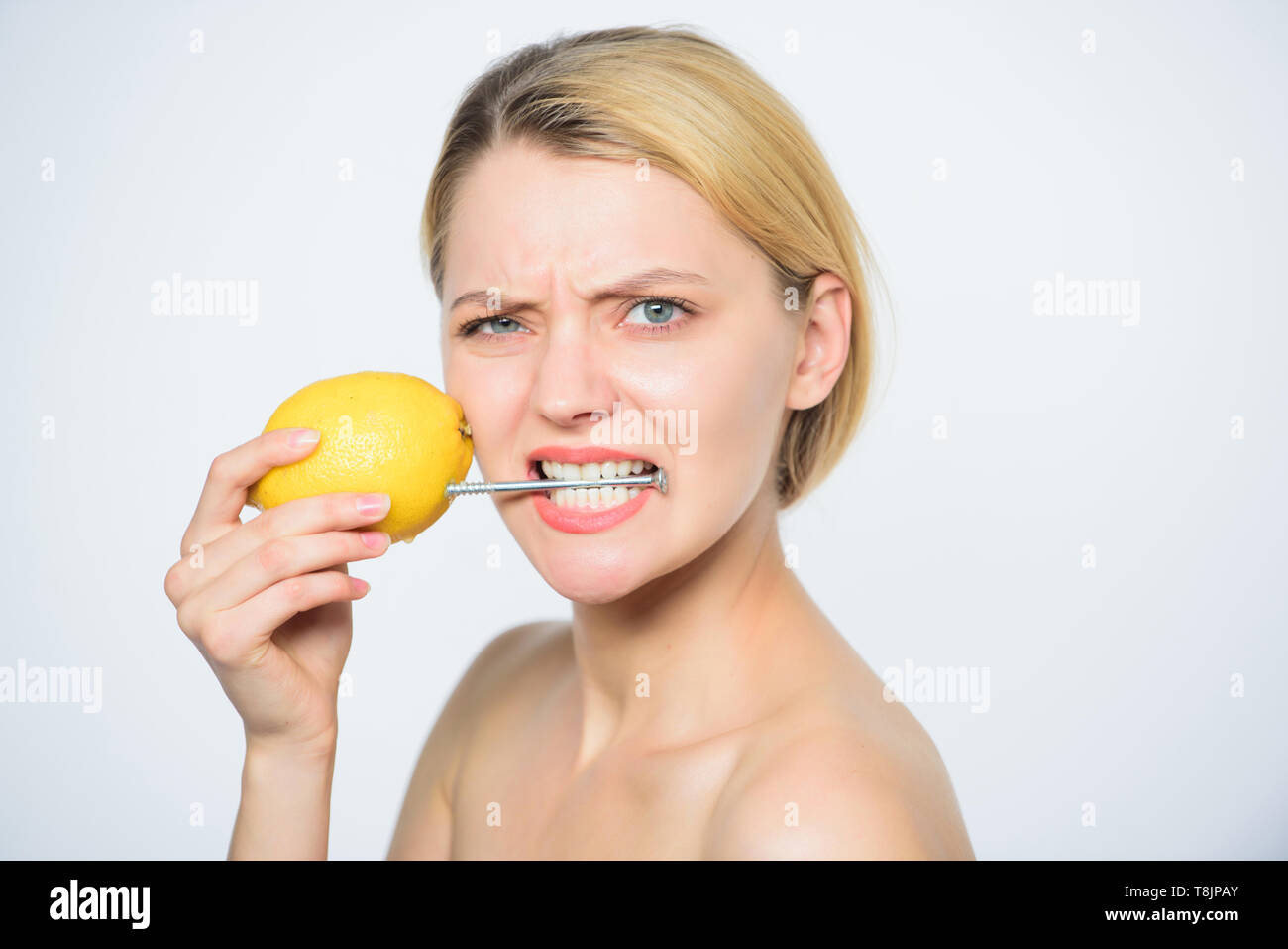 battery science project. woman with hobnail at lemon. vitamin diet food. skincare. energy and positive mood. girl with lemon charging. Recharge your body vitamins. fresh fruit juice. lemon battery. Stock Photo