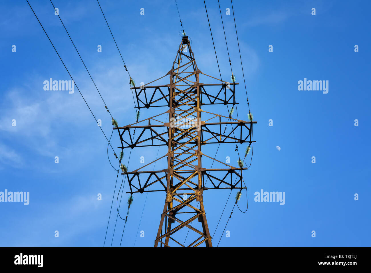 The pylon of the high-voltage power line against the blue sky. Stock Photo