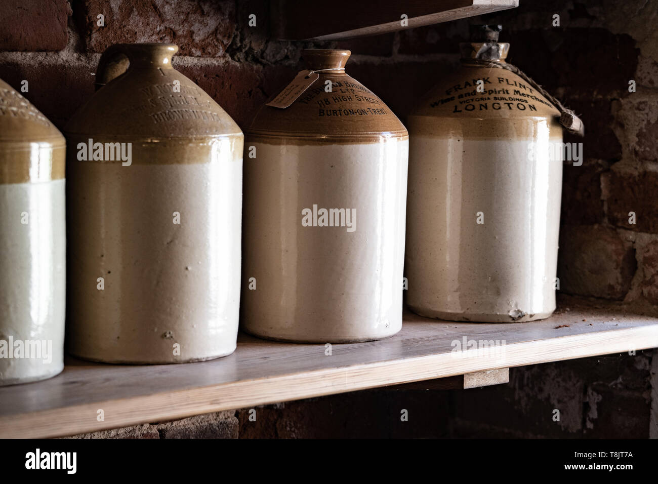 Stone jars in a pantry used for storing oil, cider or other liquids Stock Photo