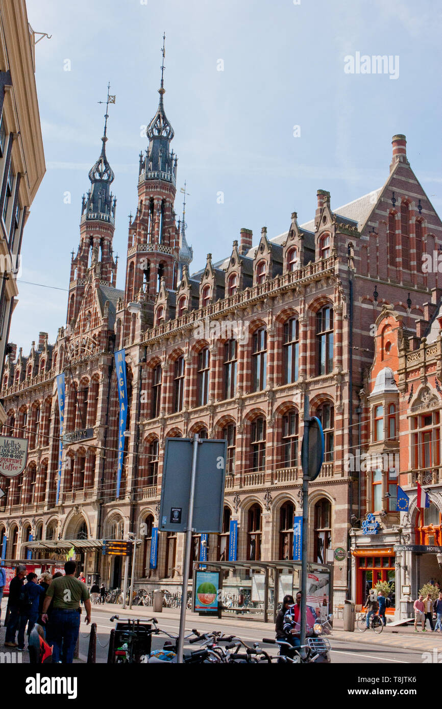 Magna Plaza in Amsterdam with twin spires in the background Stock Photo