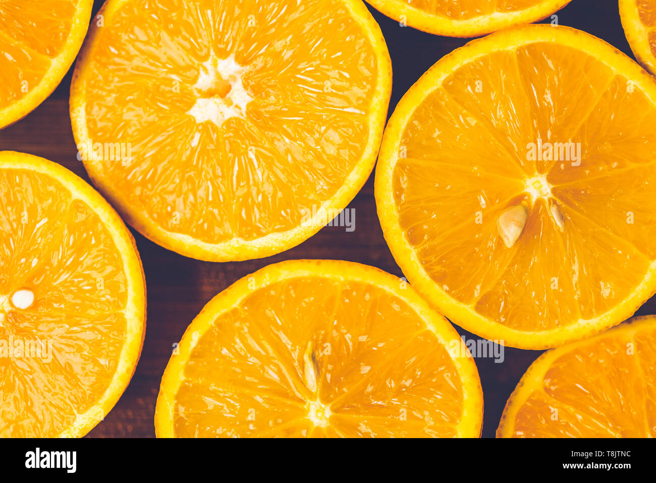 Orange background. Closeup of half cut fruits in pattern next to each other Stock Photo