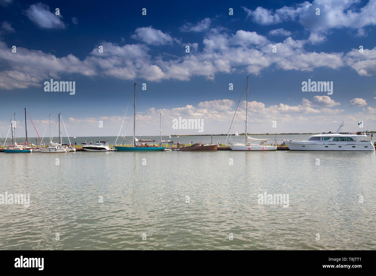 Boats at the harbor entrance of the small harbor of Volendam, Markermeer, Holland, Netherlands Stock Photo