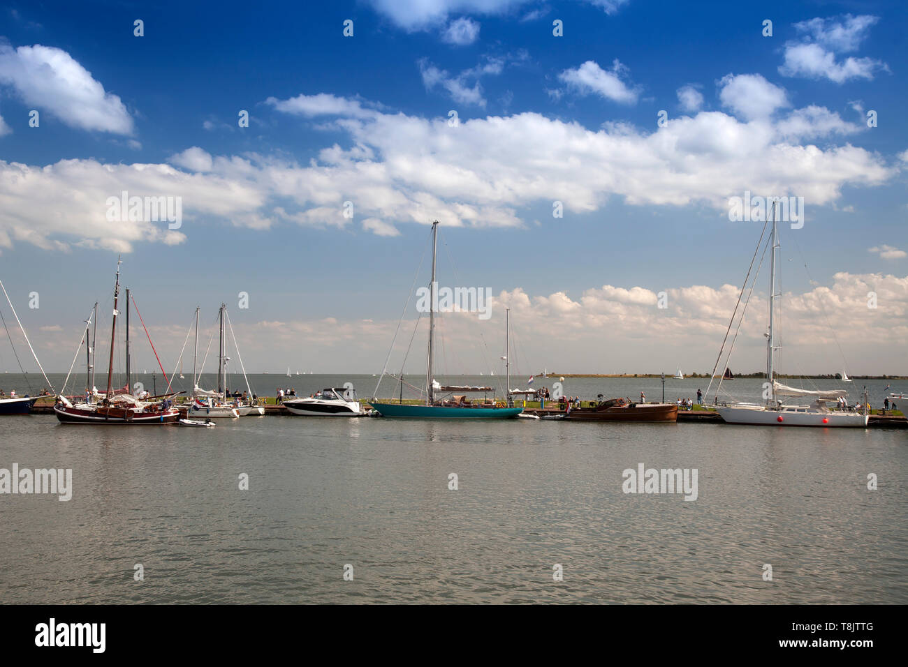 Boats at the harbor entrance of the small harbor of Volendam, Markermeer, Holland, Netherlands Stock Photo