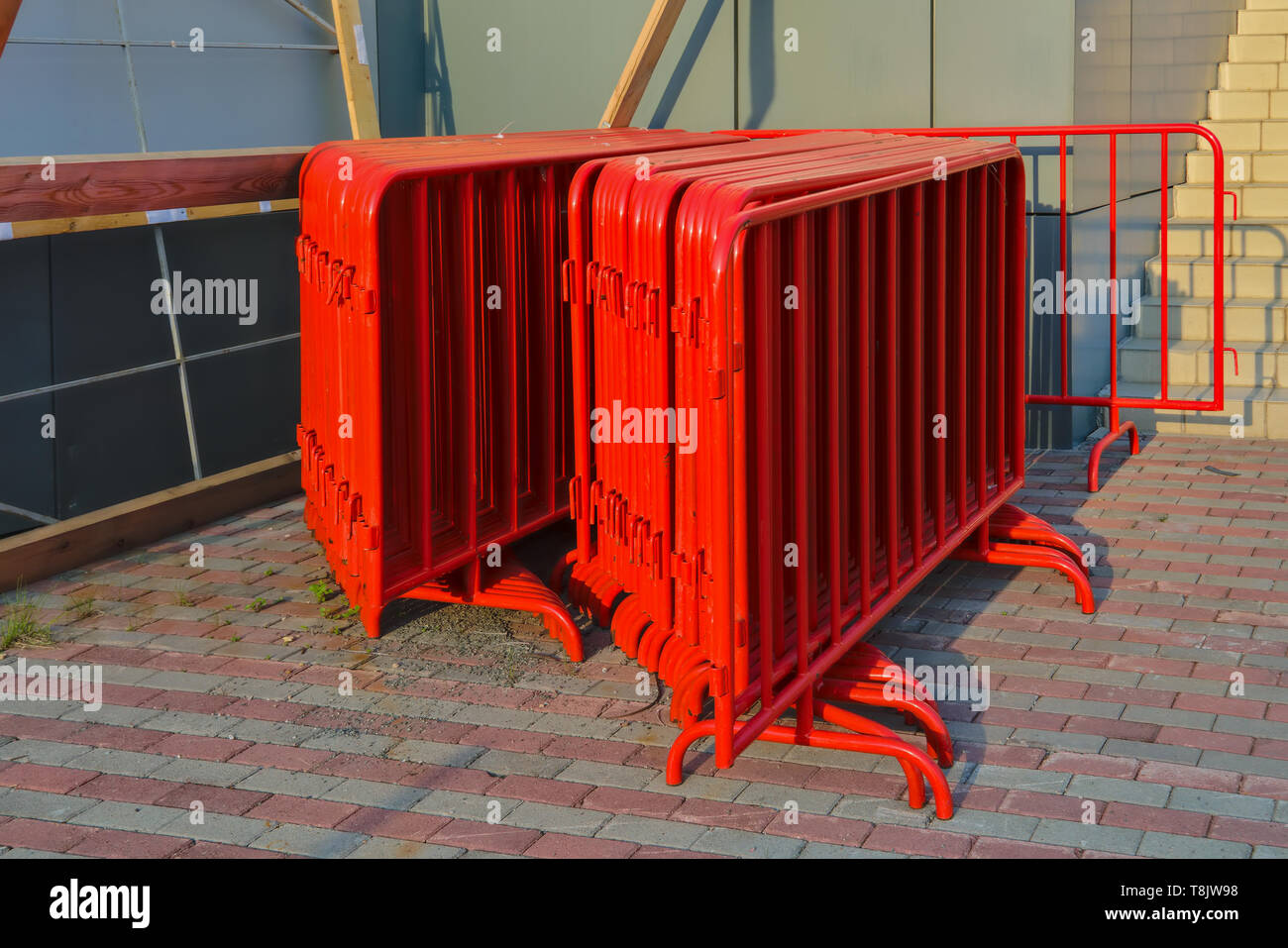 A stack of metal traffic barriers of red color on the stadium Stock ...