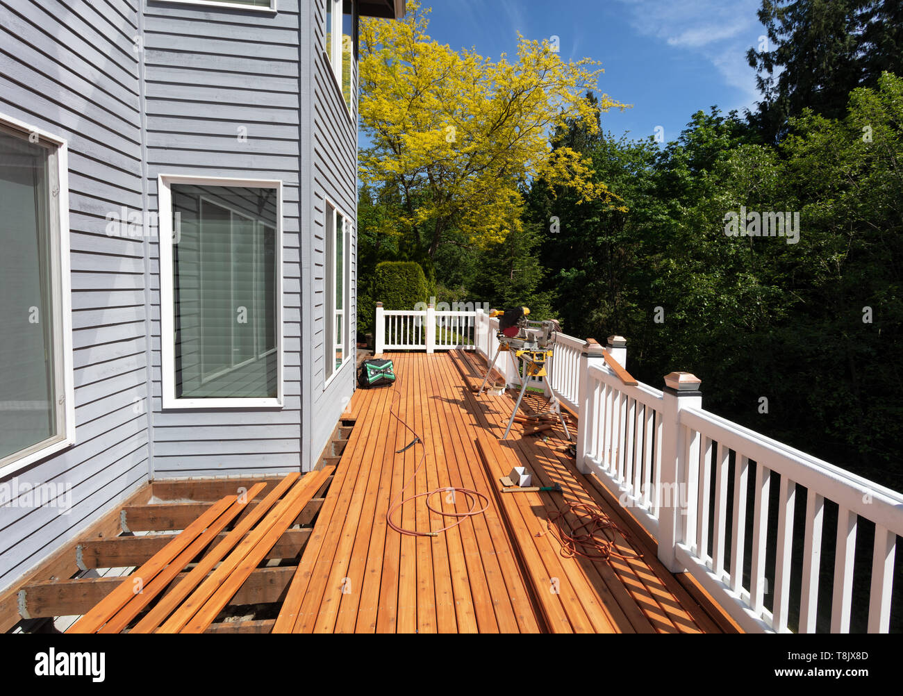 Outdoor wooden deck being remodeled with new red cedar wood floor