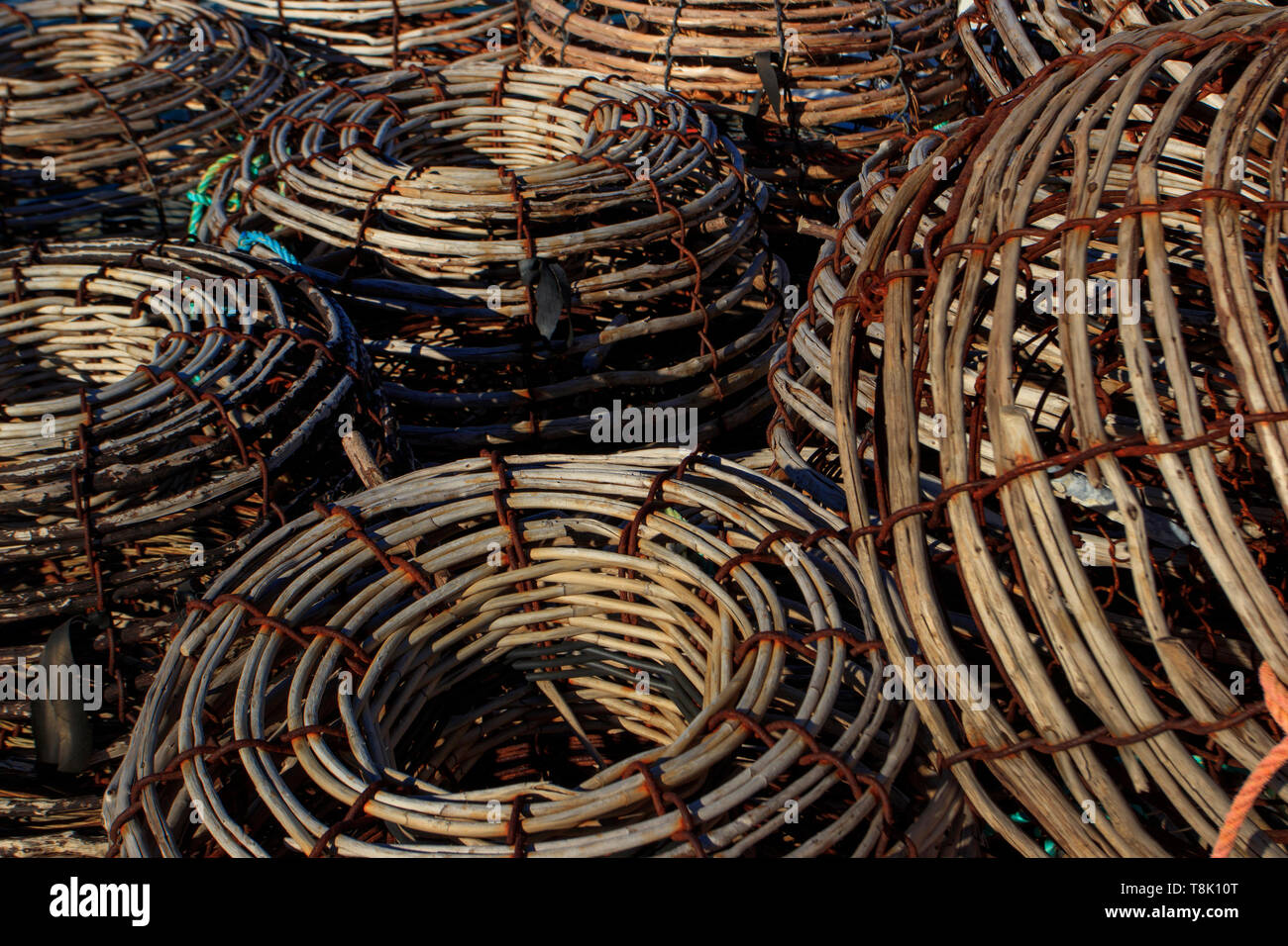 Traditional willow lobster crab fishing pots stacked on board a fishing boat on the east coast of Tasmania, Australia. Stock Photo