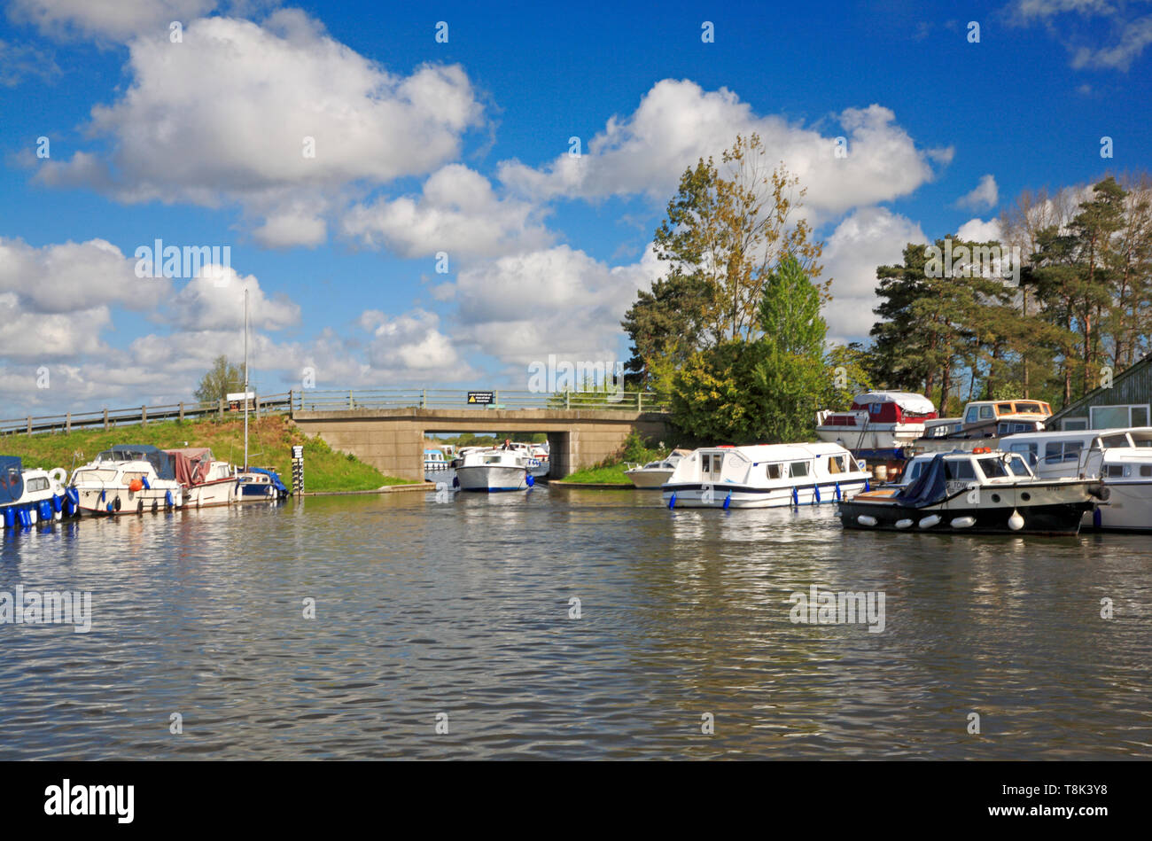 A view of a Broads cruiser passing under Ludham Bridge on the River Ant at Ludham, Norfolk, England, United Kingdom, Europe. Stock Photo
